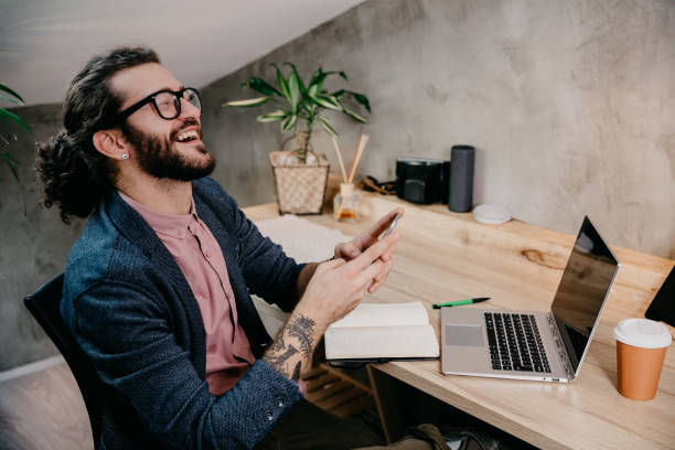 istock Bearded young businessman working at modern office 1182480866