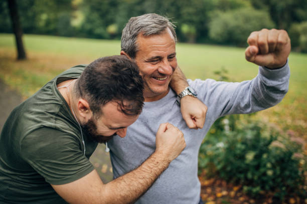 istock Father and son jogging in park 1182482528