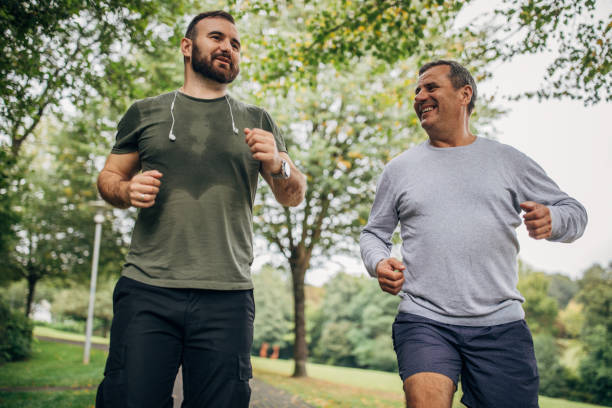 istock Father and son jogging in park 1182482684
