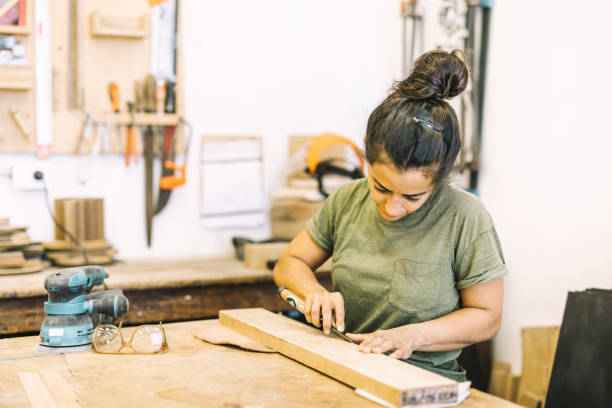 istock Young Woman Working with wood 1182482732