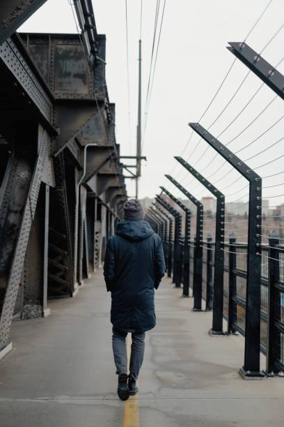 istock Man walks across High Level Bridge 1182482796
