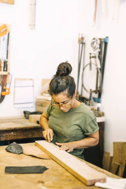 istock Young Woman Working with wood 1182483531