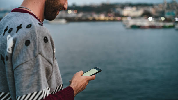 istock blond man writing message with mobile phone 1182484222