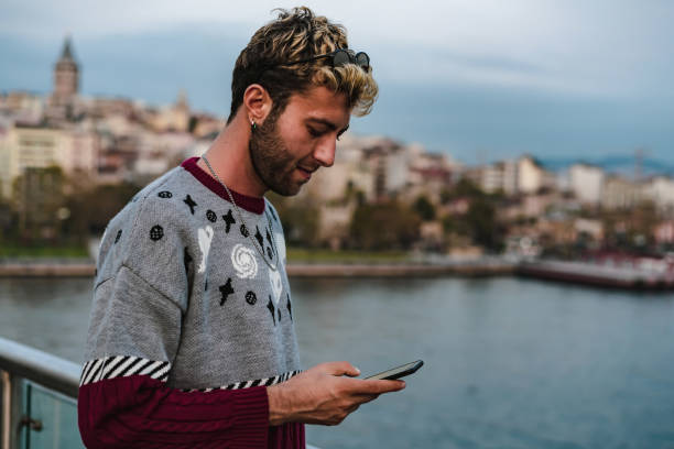 istock blond man writing message with mobile phone 1182484417