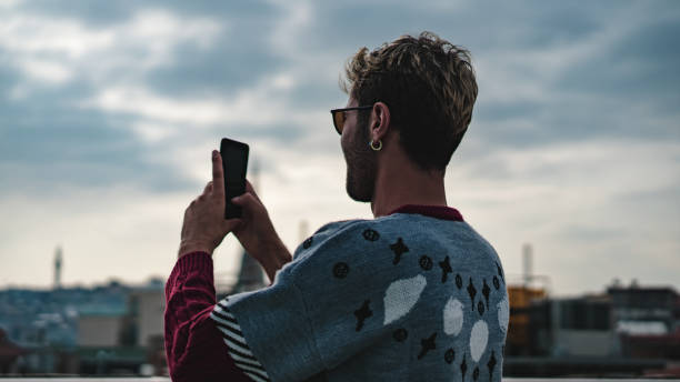 istock man taking pictures with mobile phone 1182485351