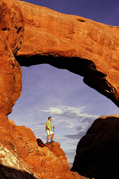 istock Hiker Standing On Rocky Ledge In Arches National Park 118248554