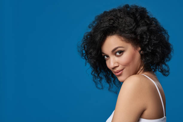 istock Mixed race woman looking at camera over blue background 1182485676