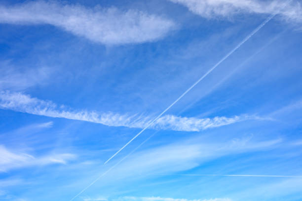 istock bright blue sky with cloud and trail from the plane 1182485768