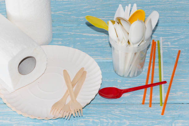 istock Disposable picnic dishes on a light background. Sale of disposable tableware. 1182486835