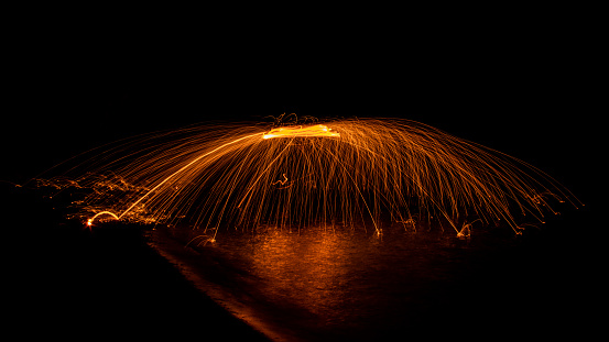 Semi Circle Golden Wire Wool Spinning in the Dark on a Lake