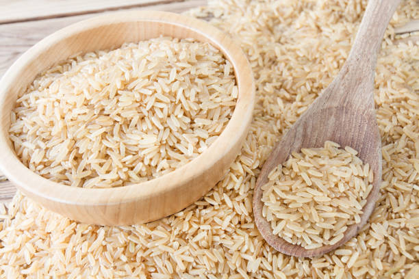 istock Rice whole grain on wooden spoon 1182488825