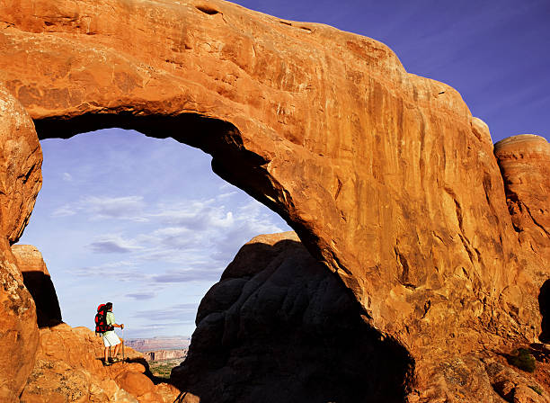 istock Backpacker Standing Under Arch In Arches National Park 118248945