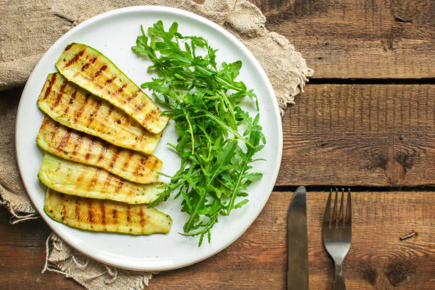 istock grilled zucchini (fried vegetables and salad, main course, healthy food) menu concept. food background. copy space. Top view 1182489902