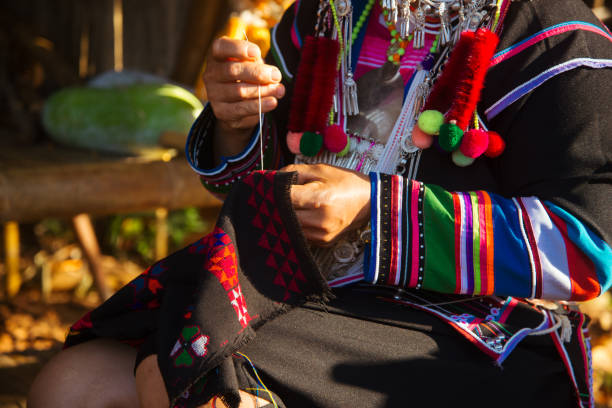 istock Akha woman is sewing 1182491564