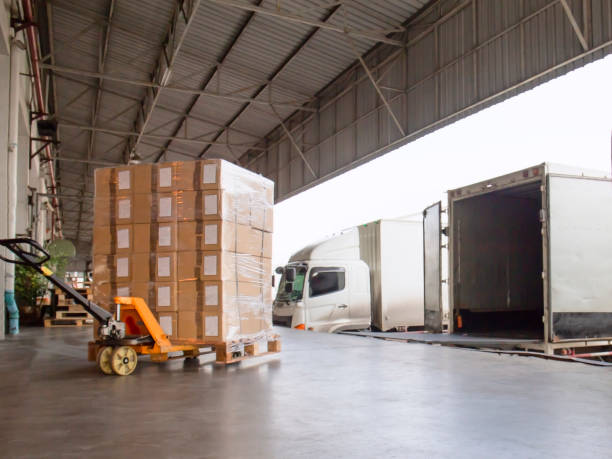 istock The truck container docking load cargo at warehouse 1182495424