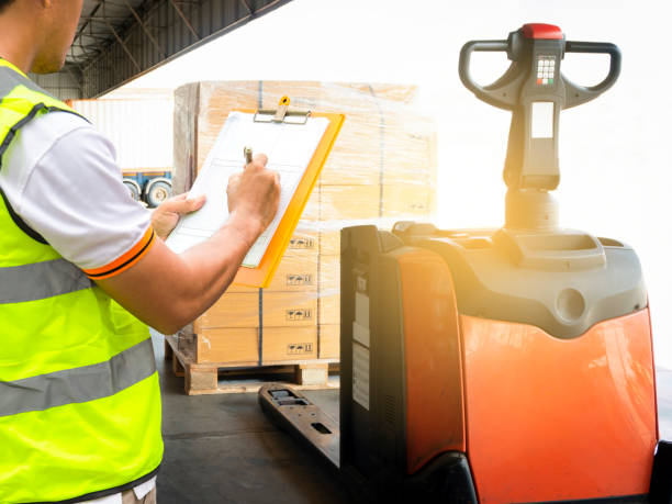 istock Warehouse worker holding clipboard inspecting checklist order shipment goods 1182495444