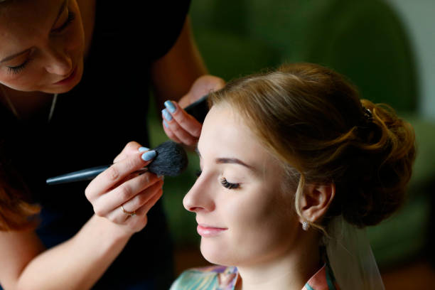 istock Make-up artist doing makeup.Make up.To smear a face with a foundation 1182495445