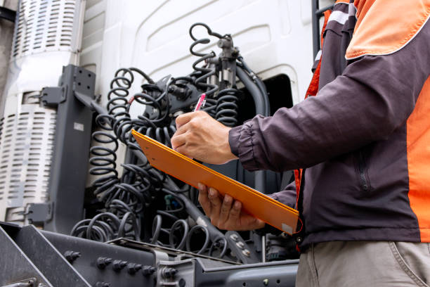 truck driver holding clipboard inspecting safety daily check the engine of semi truck - service rig imagens e fotografias de stock