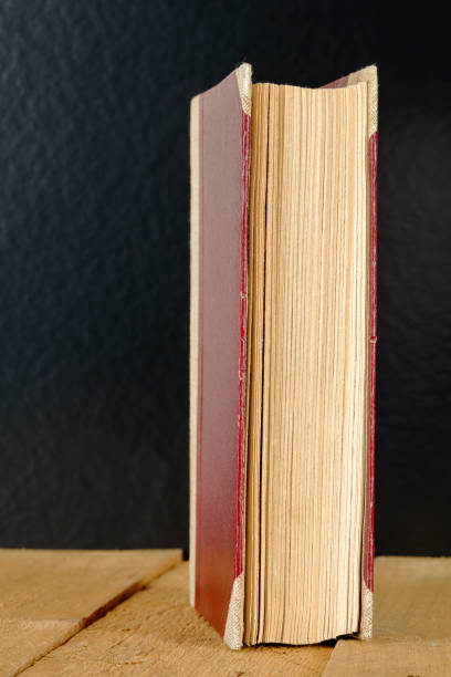 istock A closed old book was set up on rough planks 1182495732