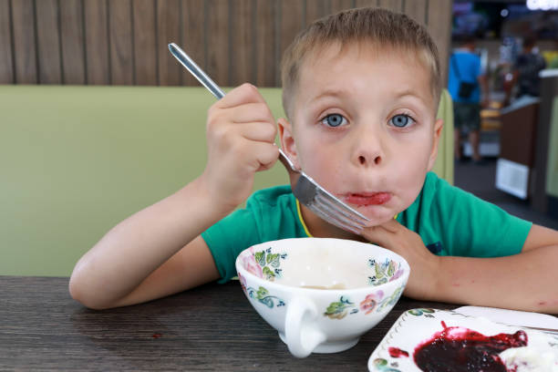 istock Boy eating vareniki 1182496019