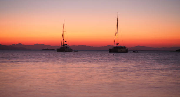 istock Sailing catamaran yachts moored in Datca bay at sunset 1182498678
