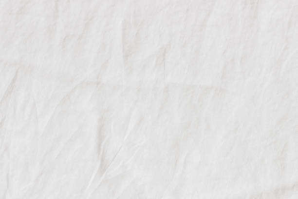 White crinkle linen texture. Closeup of fabric, tablecloth or bed linen. Light empty copy space.
