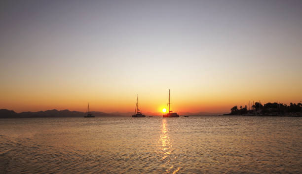 istock Sailing catamaran yachts moored in Datca bay at sunset 1182500592