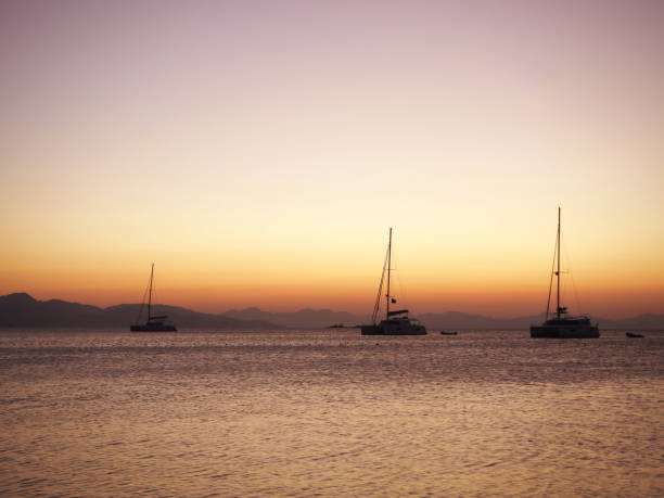istock Sailing catamaran yachts moored in Datca bay at sunset 1182500684