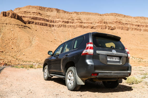 Errachidia Province, Morocco - September 27, 2019: Offroad car Toyota Land Cruiser Prado 150 at the background of rocks of the Atlas mountains.