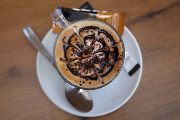 Cappuccino in a white cup on the table.