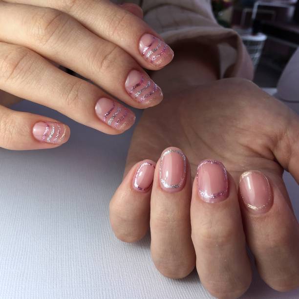 istock Female hands with stylish pink manicure on white background 1182504629