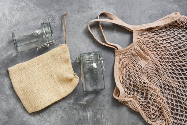 istock Cotton mesh bag and glass jars on a dark background, top view, flat lay. Zero waste. 1182504785