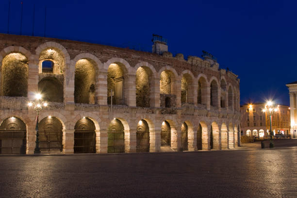 The Verona Arena at night with the interior lights lit The Verona Arena (Arena di Verona) is a Roman amphitheatre in Verona, Italy, which is internationally famous for the large-scale opera performances given there. It is one of the best preserved ancient structures of its kind. verona opera stock pictures, royalty-free photos & images