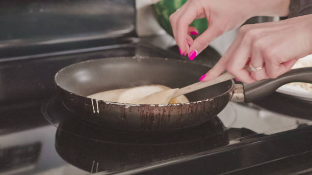 istock Cooking Russian pancake in old frying pan 1182508566
