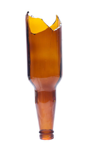 A broken beer bottle isolated on white. Often used as a weapon in bar fights.