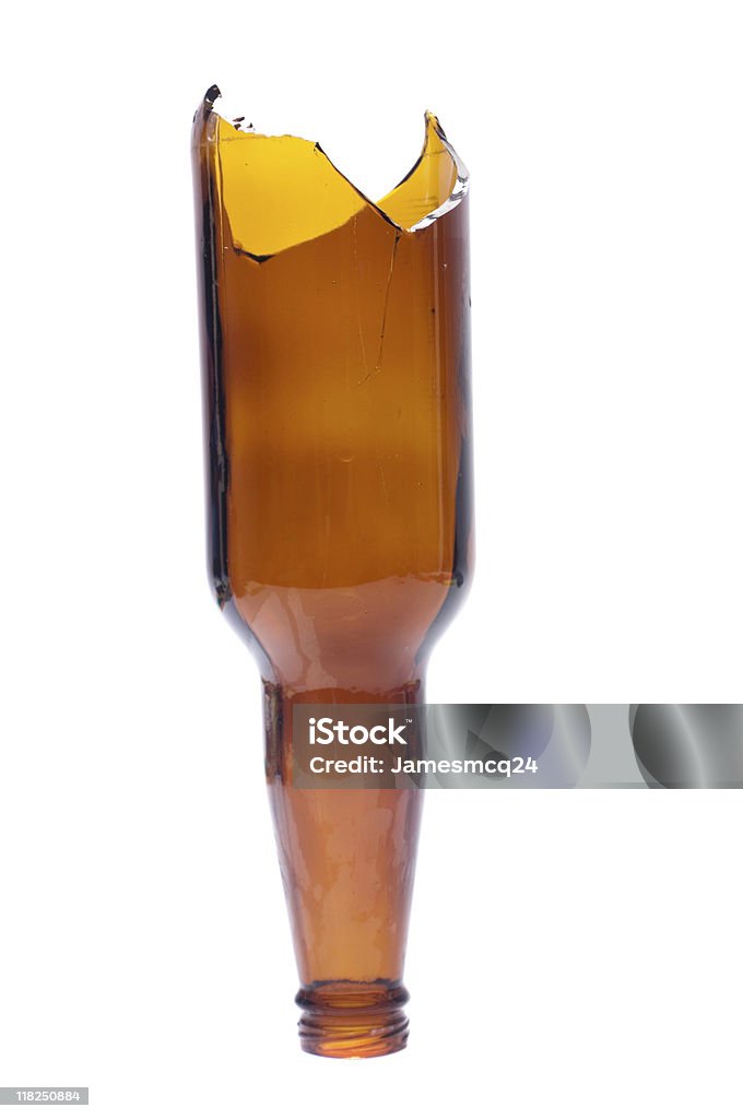 Broken beer bottle turned upside down over white background A broken beer bottle isolated on white. Often used as a weapon in bar fights. Broken Stock Photo