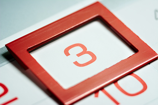 the third day of the month highlighted on the calendar with a red frame close-up macro, mark on the calendar, the third date
