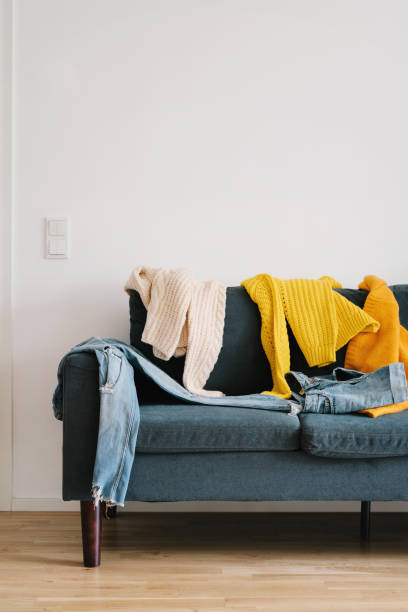istock Messy clothes on the couch 1182511143