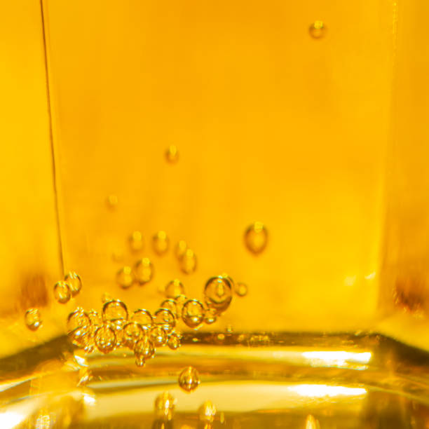 istock Yellow sparkling drink with bubbles in glass 1182511438
