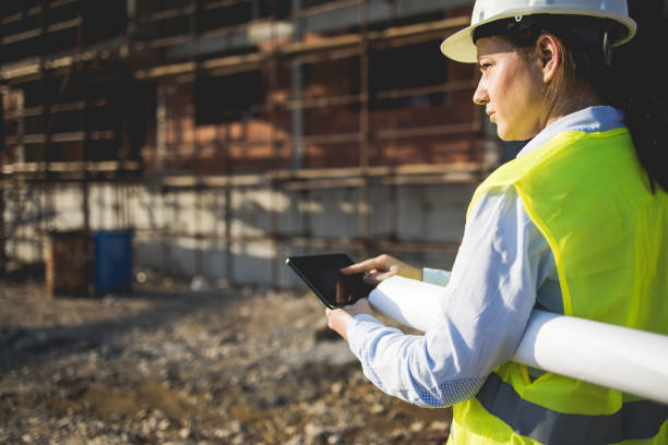 istock Three construction workers having meeting,stock photo 1182512561