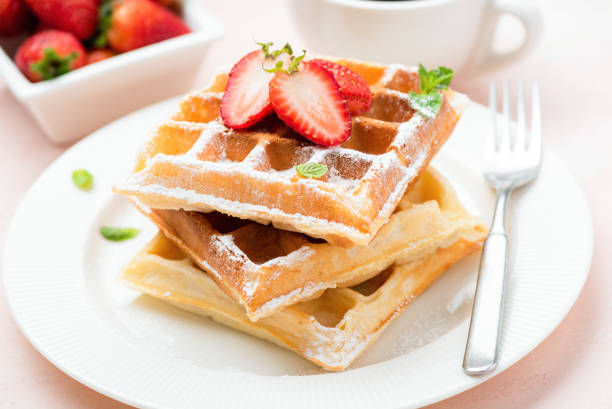 istock Belgian waffles with strawberry and powdered sugar 1182513044