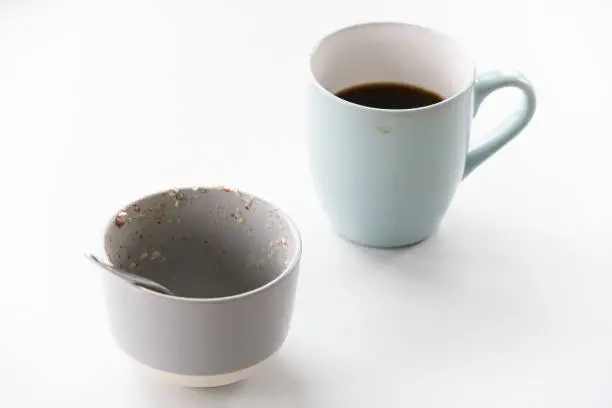 Porridge bowl and black coffee on breakfast table uk