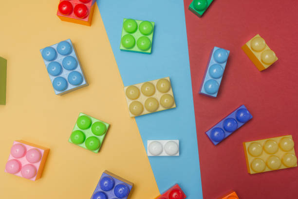 istock Some toy bricks jn colorful background. Flat lay. Top view. 1182514099