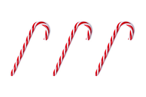 istock White and red candy canes isolated on white, top view. 1182516934