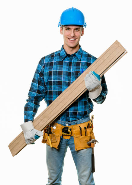 istock Confident carpenter wearing safety helmet and tool belt 1182518132