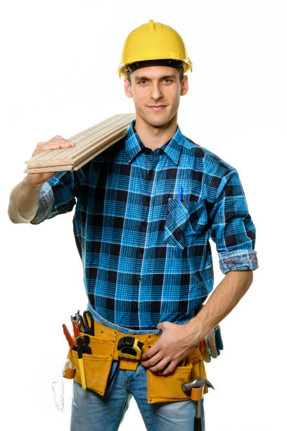 istock Confident carpenter wearing safety helmet and tool belt 1182518142
