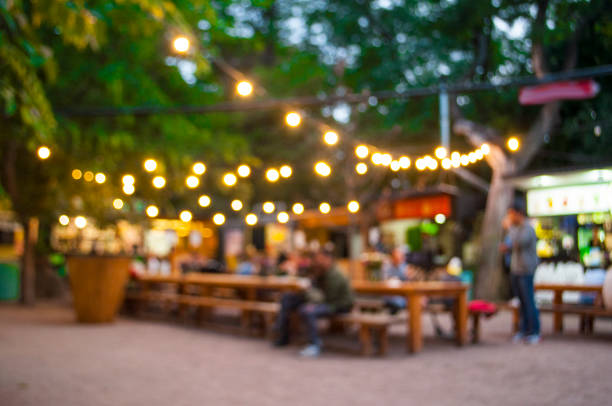 Blurred outdoor background. Beautiful bokeh background of the festival in the green city park. food court photos stock pictures, royalty-free photos & images