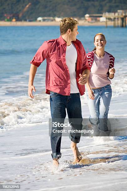 Couple Running On Beach Stock Photo - Download Image Now - Adult, Adults Only, Beach