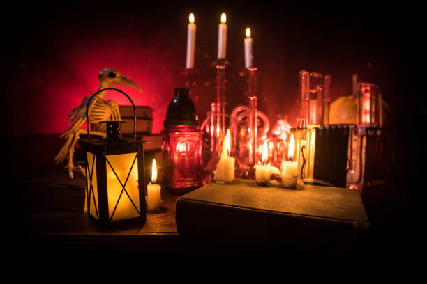 istock Halloween still-life background with different elements on dark toned foggy background. Selective focus 1182521736
