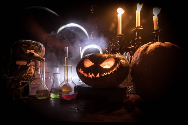 istock Halloween still-life background with different elements on dark toned foggy background. Selective focus 1182521771